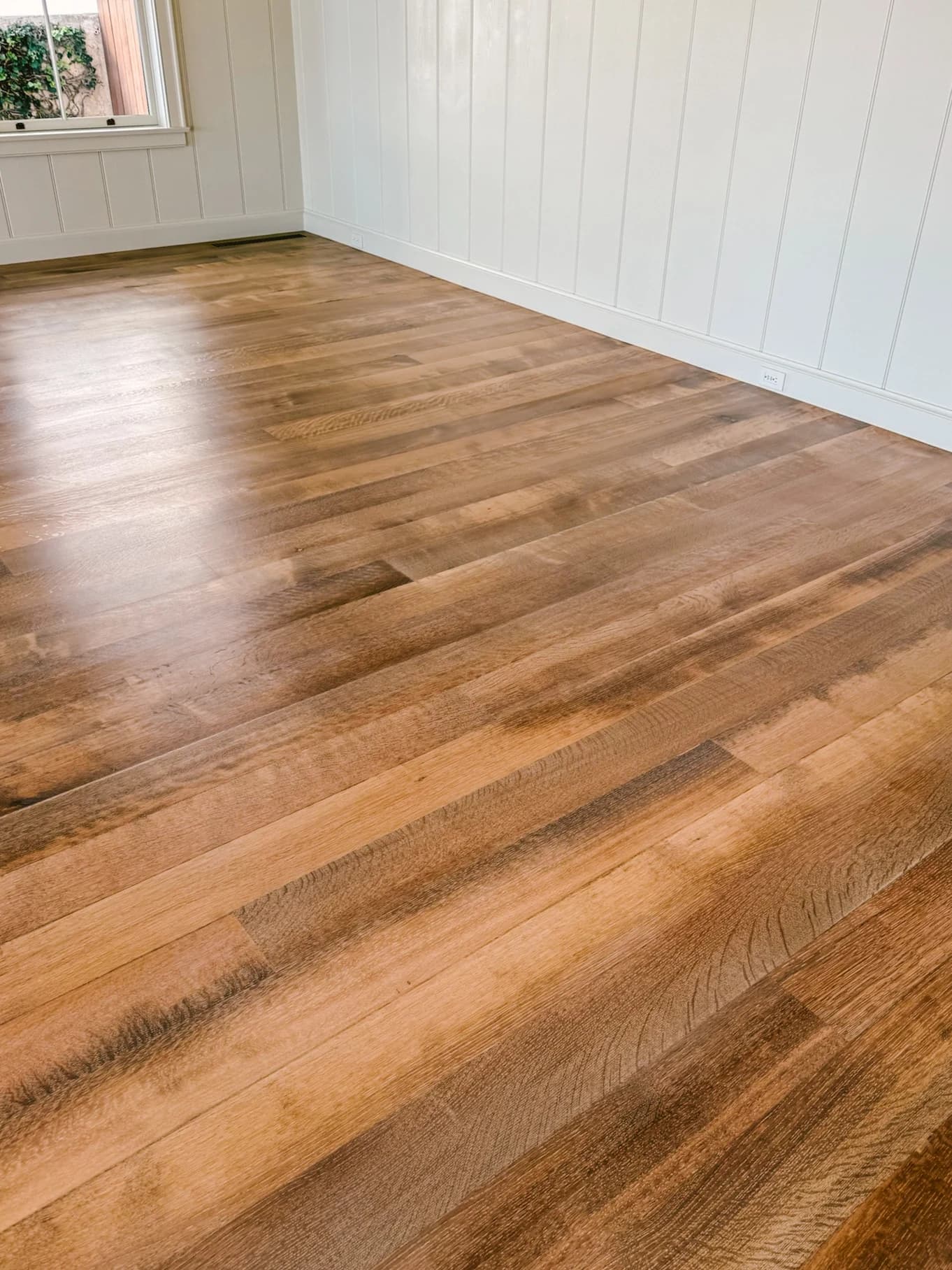 Custom-stained old growth oak flooring finished by Cal Coast Flooring in a Broad Beach home, Malibu